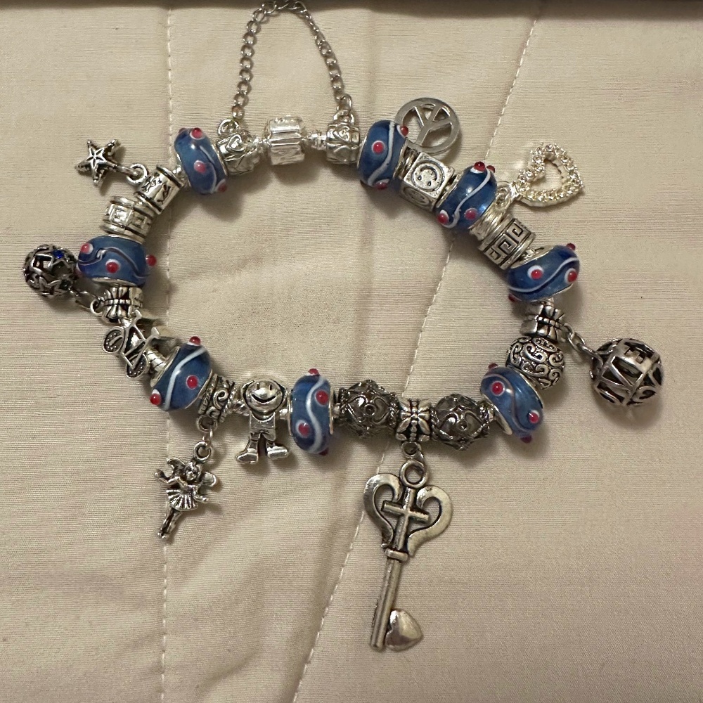 Handmade-NWOT–925 SS plated charm bracelet. Blue lamp work beads. Variety Charms